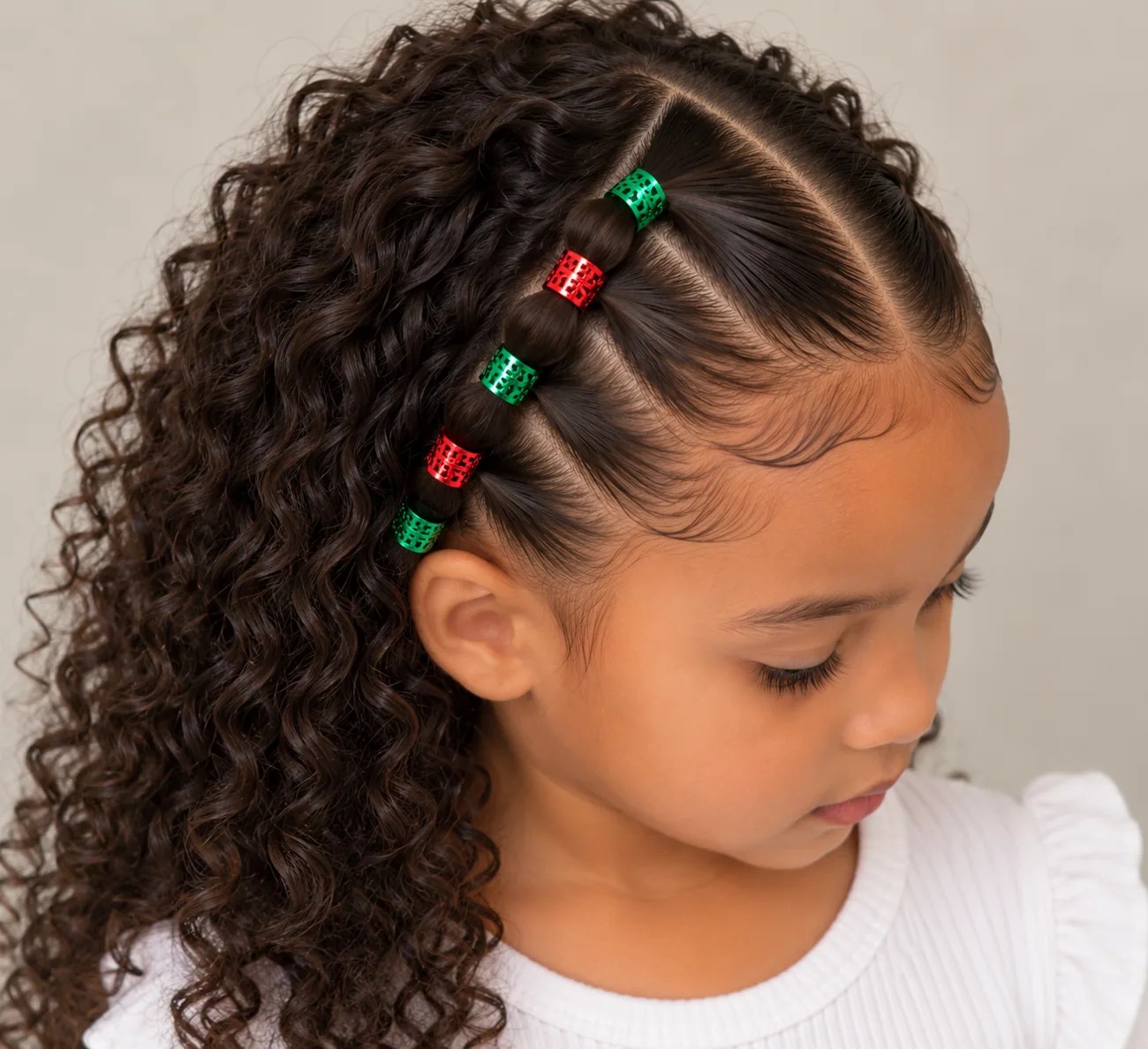 Half-up Christmas hairstyle with festive hair cuffs on curly hair